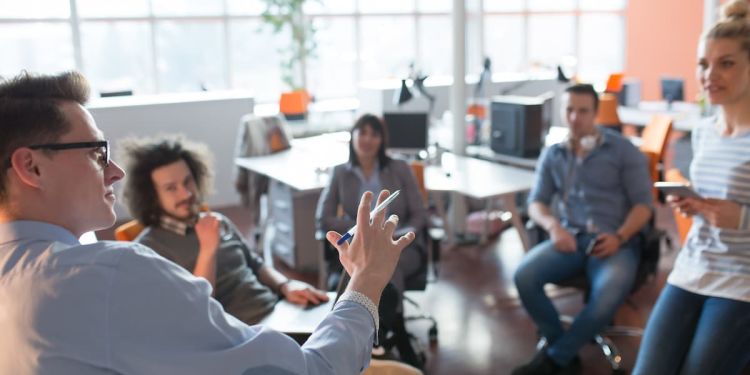 Group of individuals sitting together in an office setting having a discussion.