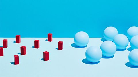 red cylinders and white balls on light blue backdrop