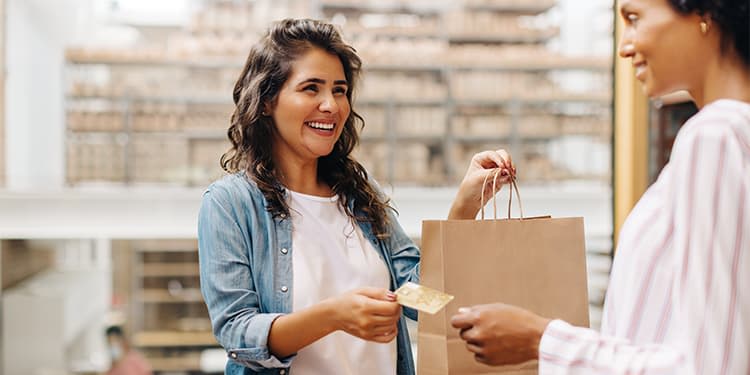 A happy customer interaction as they are paying for a product with a credit card.