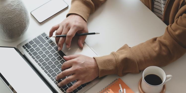 Businessman studies entrepreneurship and innovation on laptop