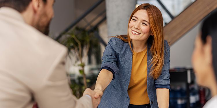 Marketer shaking hands with a customer.