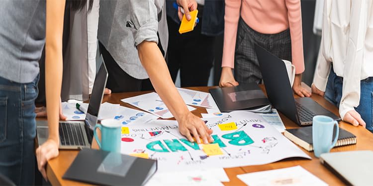 Creative professionals conducting branding exercise on table