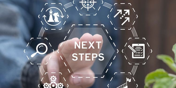 The text "next steps" is in a hexagon-shaped button surrounded by other buttons with business-related icons.