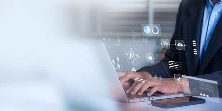 Business professional typing on a laptop with artificial intelligence icons floating above it