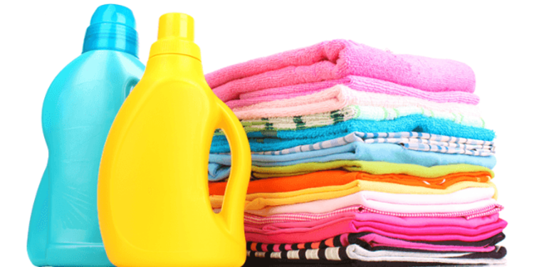 image of detergent bottles next to neatly folded laundry