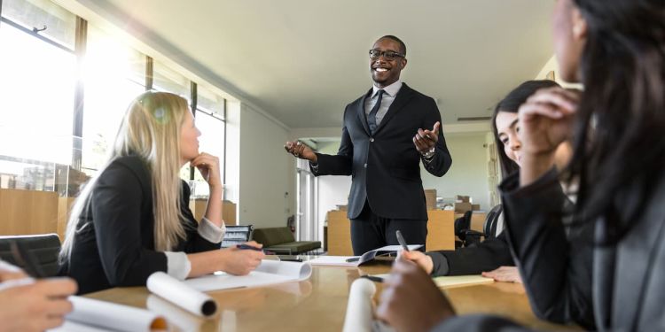 Business professional using leadership skills during a team meeting