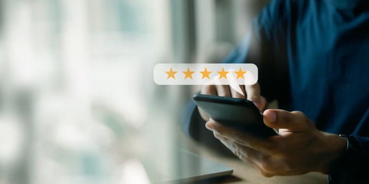 Customer leaving a five-star review on their cell phone.