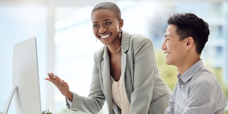 Two team members taking an online corporate learning course.