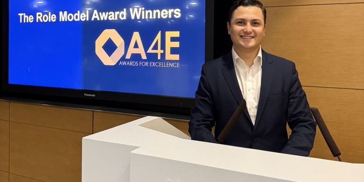 A photo of Francisco Gallegos at a podium being awarded the Operations Role Model Award.