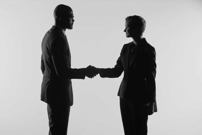 Two people shaking hands in agreement